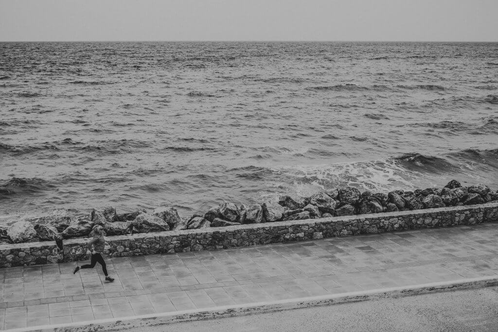 AONIJIE, PTT Outdoor, woman jogging on city street at seaside PPRVV57 bnw copy 1,
