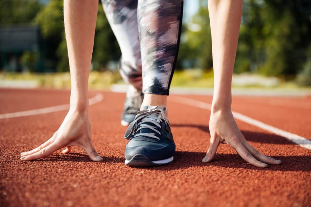 5 Tips to keep up with your fitness resolution this year! | PTT Outdoor 5 Tips to keep up with your fitness resolution this year!, PTT Outdoor, cropped image of a female sprinter getting ready PZ6PPGL 2,